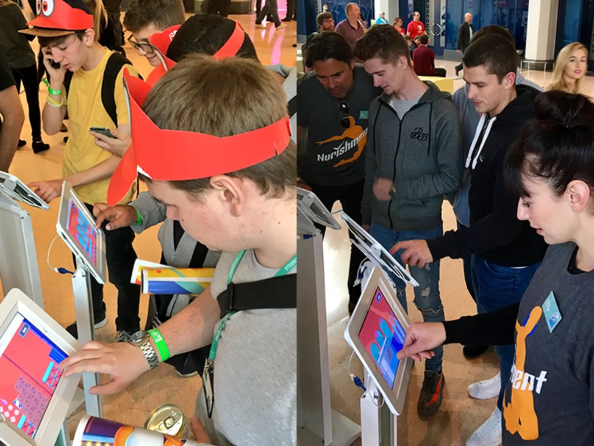 People playing Nurishment's game at an exhibition